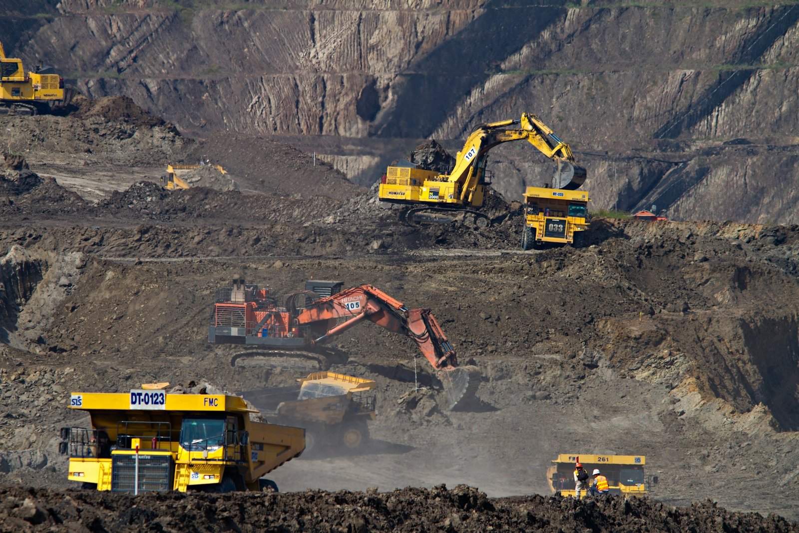 Excavators and haul trucks working an open-cast lignite mine